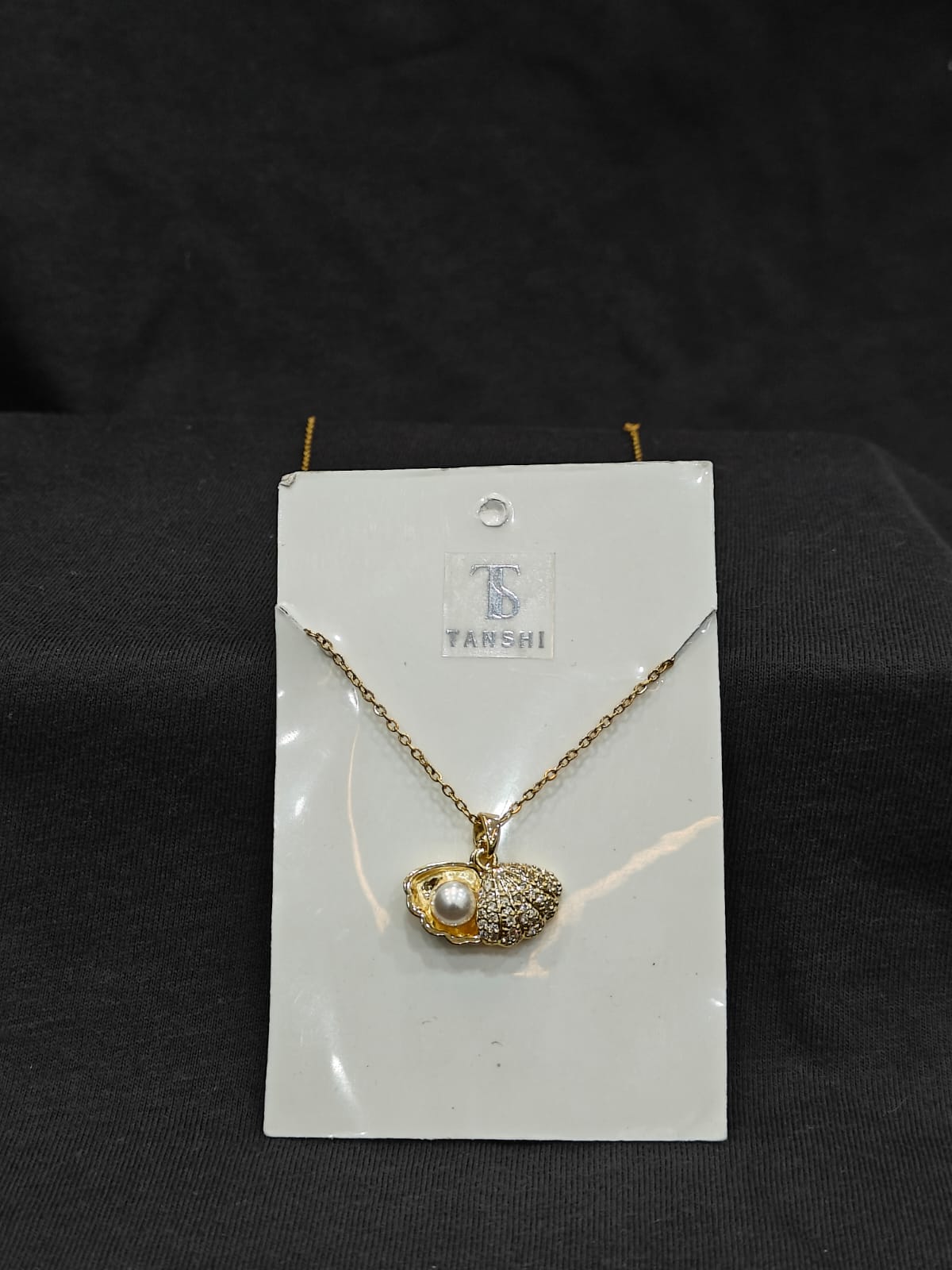 Seashell with pearl necklace